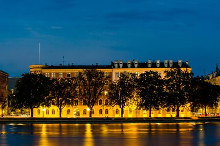 Evening view of old historical buildings in Copenhagen, Denmark, over the water. Shot at twilight (blue hour)の写真素材