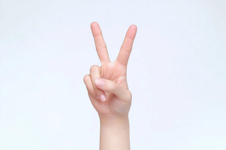 Hand with victory sign isolated on white background, clipping path included.の素材