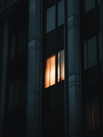 Modern office building with windows and lights at night. 3D renderingの素材