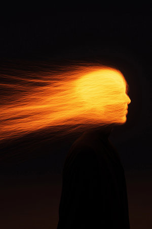 Man with fire on his head, conceptual image of a man with fireの素材