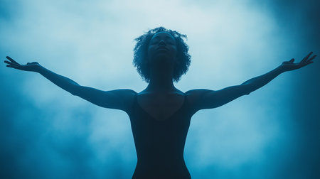 Silhouette of african american woman with open arms on dark backgroundの素材