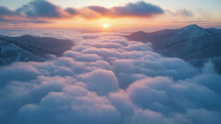 Aerial view of the sunrise over the clouds in the mountains.の素材