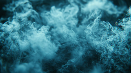 Close up of blue cloud of smoke on black background. Selective focus.の素材