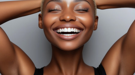 Close up portrait of beautiful young african american woman with white teeth smiling.の素材