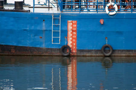 Orange and white scale on a blue boatの写真素材