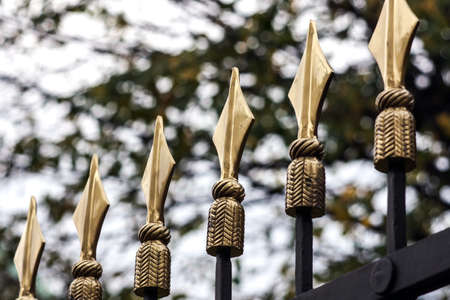 details of iron gates with gold topの写真素材