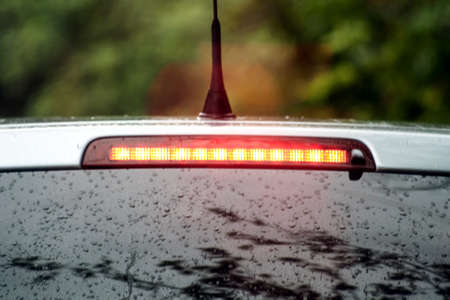 car brakes on the rain the brake lampの写真素材