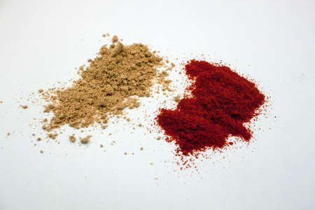 Ginger and paprika powder on a white background