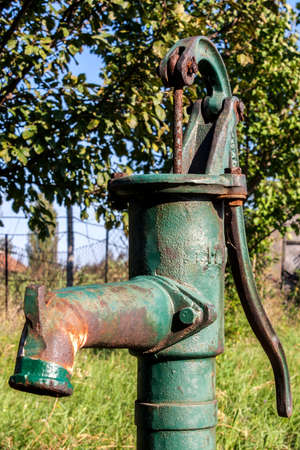 Old well pump for clean waterの写真素材