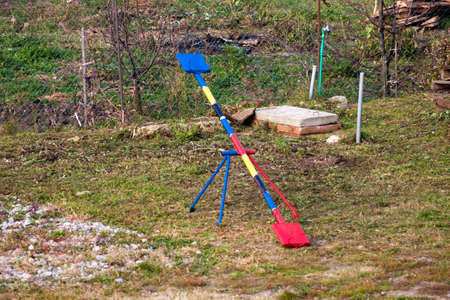 old seesaw on an abandoned playground