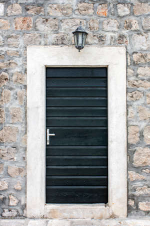 Black door on a  stone buildingの写真素材