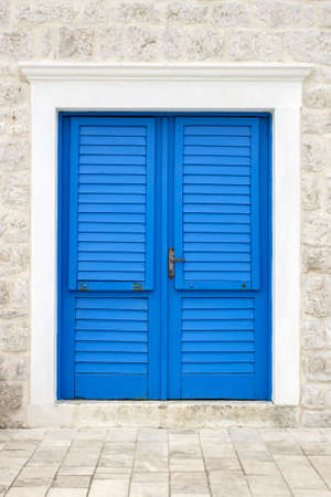 Blue door on a white stone buildingの写真素材