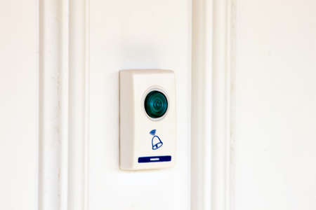 white doorbell with a blue plastic buttonの写真素材