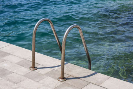 A ladder to the swimming poolの写真素材