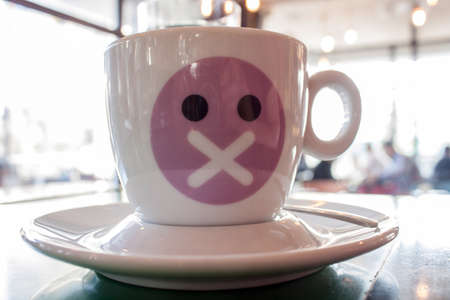 Cup for espresso coffee with coffee shop in backgroundの写真素材