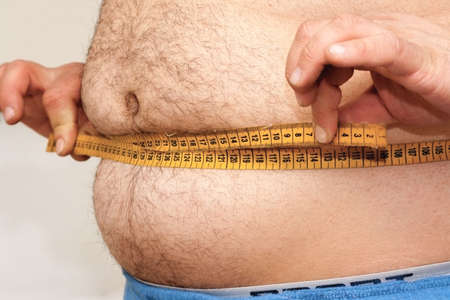 Fat man and measuring tapeの写真素材