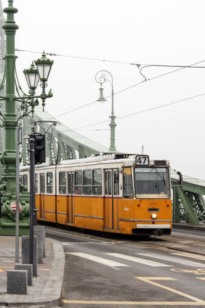 Budapest, Hungary - January 3, 2014: No 47 tram passing by Budapest. Old yellow tram in Budapest, Hungary.のeditorial素材