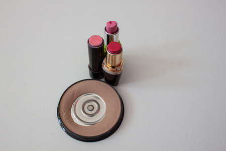 Worn face powder and lipstick on a white backgroundの写真素材