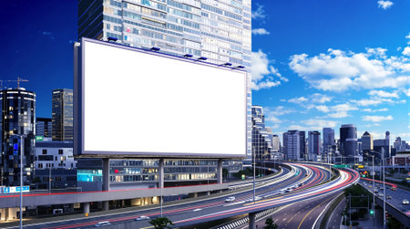 Blank billboard on the road with cityscape background at night.の素材