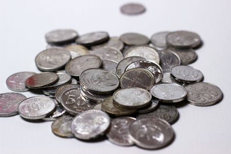 Coins scattered and overlapping. Indonesian Rupiah and isolated