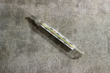 A thermometer on the stone background