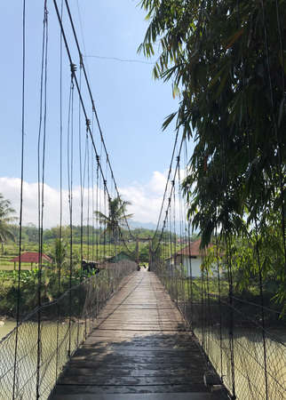 As a connection between the land separated by the river, this suspension bridge presents a very beautiful view of the countrysideの写真素材