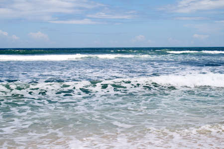 The foam of the waves in the sea that decorates the seashore in summer. Holidays with an atmosphere like this are very enjoyableの写真素材