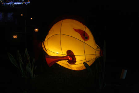 A fish-shaped lantern in a lantern gardenの写真素材