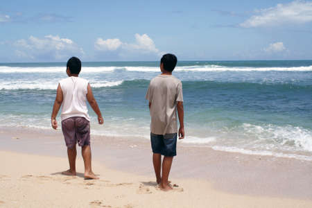 a beach with a small cliff on the edge is often used by people to take picturesの写真素材