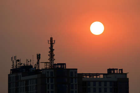 Silhouette of a building with the side sunlit in the afternoon and the other side that is not...