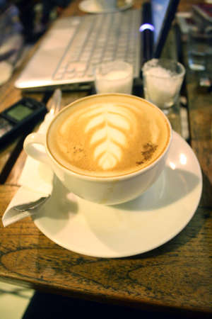 A barista can make coffee art by making coffee as canvas and milk as the inkの写真素材