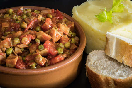 Atew of seitan and peas with mashed potatoes and fresh breadの写真素材