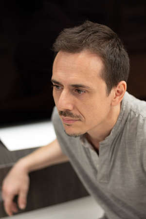 Man profile portrait, blurred background, vertical image
