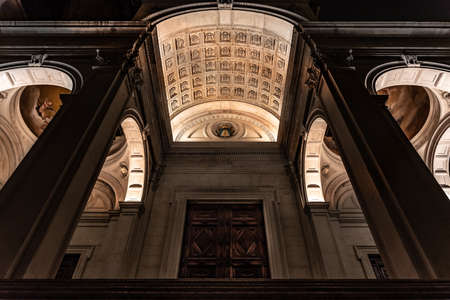 View from below of the main entrance of the Cathedral of Sant'Alessandro, the Cathedral of Bergamo Alta illuminated at night. Vertical imageの写真素材