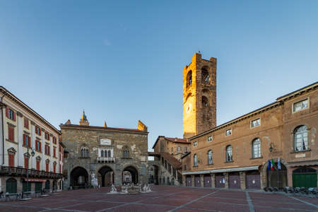 Panorama of Piazza Vecchia with the Contarini Fountain and in the background the Palazzo della Ragione and the bell tower called Campanone in Piazza Vecchia in Bergamo Alta, Italyのeditorial素材