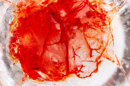 Image of blood-colored liquids mixed with other organic fluids, abstract chemical detail