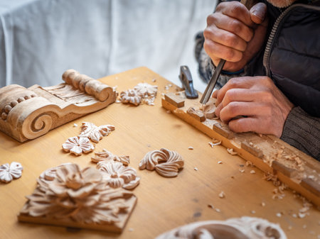 The hands of a craftsman carve wooden decorations, street photographyの写真素材