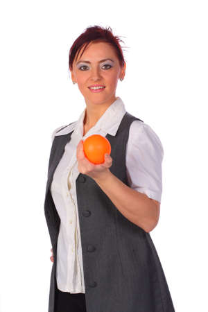 Elegant smiling businesswoman wearing a vest holding a stressball, isolated on whiteの写真素材