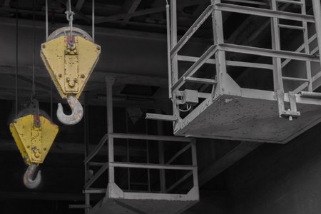 Two steel hooks of an old crane system in a disused coal mine