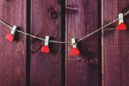 Hearts on cord with wooden background toned selective focusの写真素材