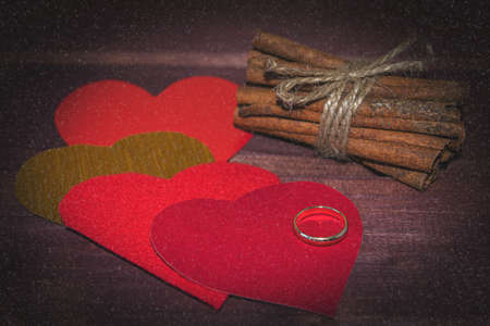 Hearts, cinnamon sticks with snowfall effect toned selective focusの写真素材