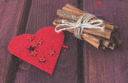 Hearts, cinnamon sticks with snowfall effect toned selective focusの写真素材