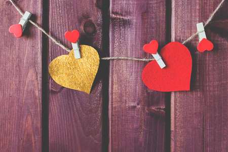 Hearts on cord with wooden background toned selective focusの写真素材