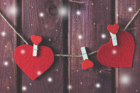 Hearts on the cord with snowfall effect toned selective focusの写真素材
