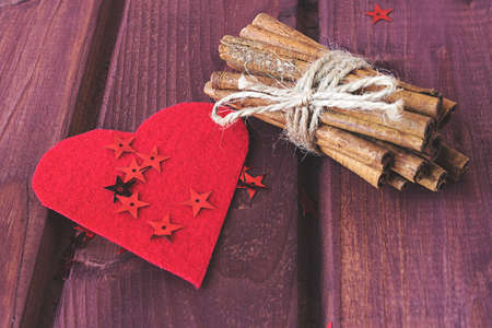 Hearts, cinnamon sticks with snowfall effect toned selective focusの写真素材