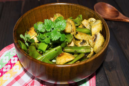 Homemade fried mushrooms with peas and mint toned selective focusの写真素材