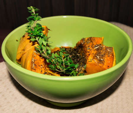 Pumpkin baked with spices and decorated with thymeの写真素材