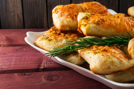 Puff pastry with cheese and herbes de Provence on wooden planks
