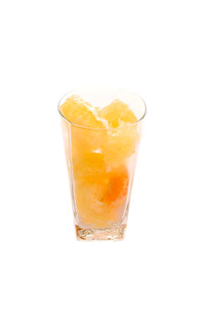 Pomelo and tangerine slices citrus in long glass with water drops isolated tonedの写真素材