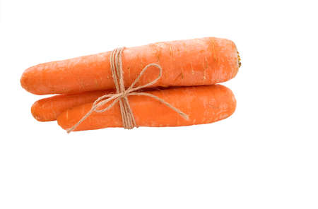 Three carrots with beige cord around and little bow isolated tonedの写真素材